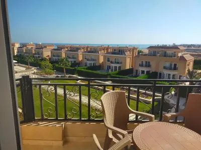 a balcony with chairs and a view of a city at Red Sea Panorama in Hurghada