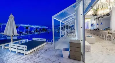 a room with a bed and a pool at night at Red Sea Panorama in Hurghada