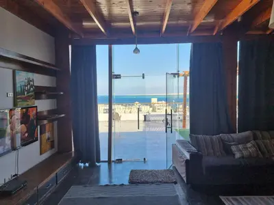 a living room with a couch and a view of the ocean at Askyhomes in Hurghada