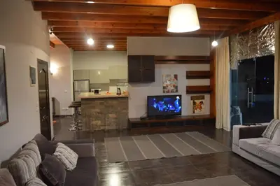 a living room with a couch and a tv at Askyhomes in Hurghada
