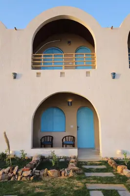 a building with blue doors and a balcony at Noprea Boutique Hotel in Aswan