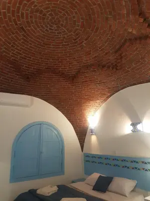 a bedroom with a brick ceiling and a bed at Noprea Boutique Hotel in Aswan
