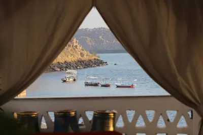 a view of boats in the water from a window at Noprea Boutique Hotel in Aswan