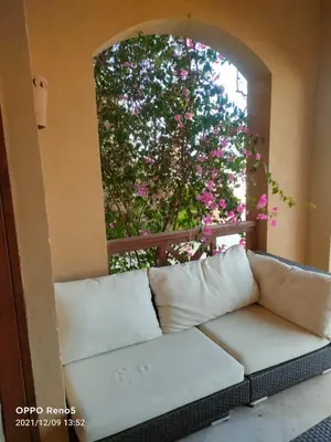 a couch sitting in a room with a window at Babel Apartments el gouna in Hurghada