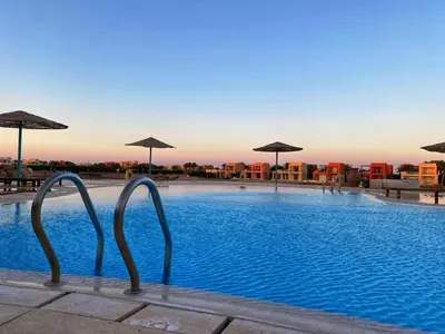 a swimming pool with umbrellas on top of a building at Babel Apartments el gouna in Hurghada