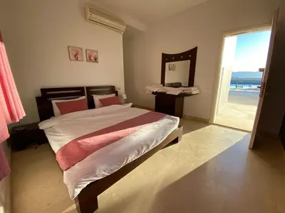 a bedroom with a bed with a view of the ocean at Babel Apartments el gouna in Hurghada