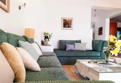 a living room with a green couch and a table at Babel Apartments el gouna in Hurghada