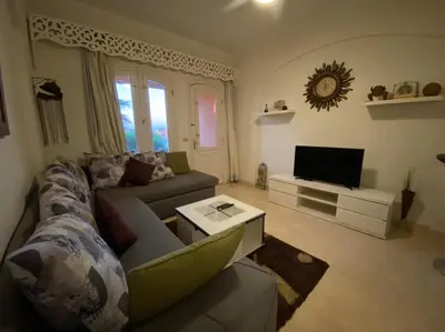 a living room with a couch and a tv at Babel Apartments el gouna in Hurghada