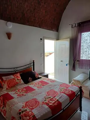 a bedroom with a bed with a red and white quilt at Sunny sea in Quseir