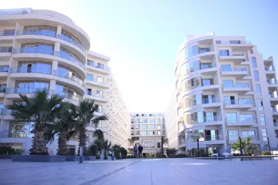 two tall buildings with palm trees in front of them at Scandic resort in Hurghada