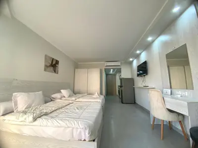 a bedroom with a large bed and a desk at Scandic resort in Hurghada