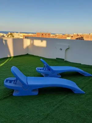 two blue airplanes sitting on the grass on a roof at Sunny sky in Quseir