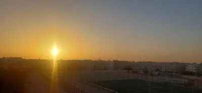a sunset over a city with a tennis court at Sunny sky in Quseir