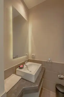 a bathroom with a white sink and a mirror at Bright 2-Bedroom Apartment with Golf Course & Pool View l Cyan, El Gouna in Hurghada