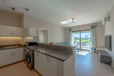 a large kitchen with a sink and a dishwasher at Bright 2-Bedroom Apartment with Golf Course & Pool View l Cyan, El Gouna in Hurghada