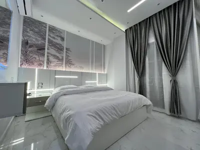 a bedroom with a bed and a desk and a window at BS Lodging 16- Next to Dream Beach in Hurghada