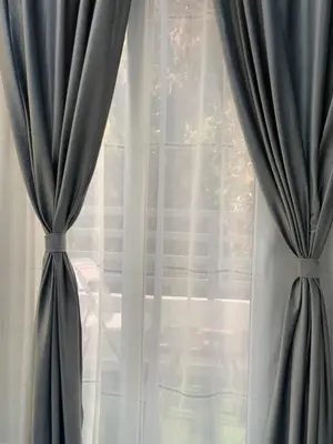 a window with blue curtains in a room at BS Lodging 16- Next to Dream Beach in Hurghada