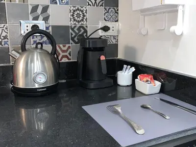 a kitchen counter with a tea kettle and utensils at BS Lodging 16- Next to Dream Beach in Hurghada