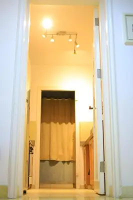 a hallway with a door with a window with a curtain at Sun Of Marina in Hurghada
