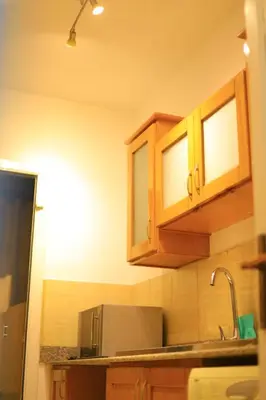 a kitchen with wooden cabinets and a sink at Sun Of Marina in Hurghada