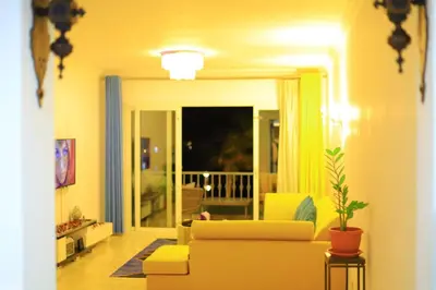 a living room with a yellow couch and a plant at Sun Of Marina in Hurghada