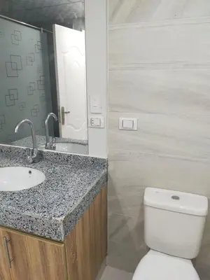 a bathroom with a toilet and a sink and a mirror at Scandic 1 in Hurghada