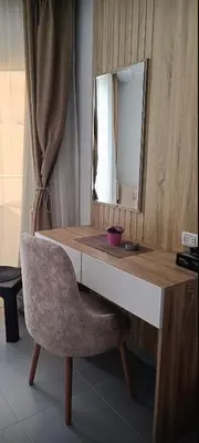 a dressing table with a chair and a mirror at Scandic 1 in Hurghada