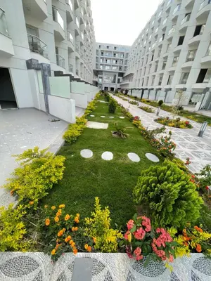 a garden in the middle of a building with flowers at Scandic 1 in Hurghada