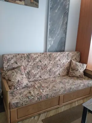 a couch sitting in a room with a flower pattern at سيسيليا اتش in Hurghada