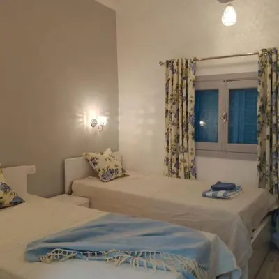 a bedroom with two beds and a window at desert pearl beautiful cosy new home in Luxor