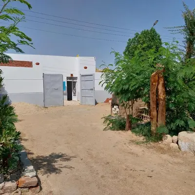 a white building with a door on the side of it at desert pearl beautiful cosy new home in Luxor