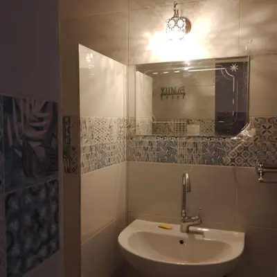 a bathroom with a sink and a mirror at desert pearl beautiful cosy new home in Luxor