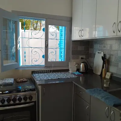 a kitchen with a stove and a window in it at desert pearl beautiful cosy new home in Luxor