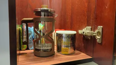 a wooden shelf with a bottle and a cup on it at Oyster Bay Beach Resort - Luxury Serviced Condo in Marsa Alam City