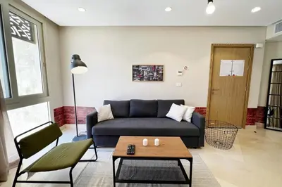a living room with a couch and a coffee table at Rugged & Relaxed 1 BDR Mangroovy Free Pool & Beach Access in Hurghada