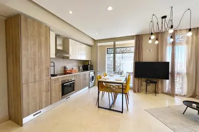 a kitchen with a table and a dining room at Enticing & Earthy 1 BDR Mangroovy Free Pool & Beach Access in Hurghada