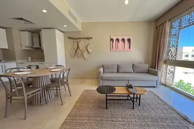 a living room with a couch and a table at Perky 1 BDR Mangroovy Free Pool & Beach Access in Hurghada