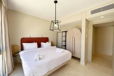 a bedroom with a bed with two towels on it at Perky 1 BDR Mangroovy Free Pool & Beach Access in Hurghada