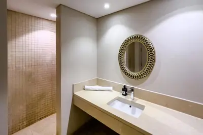 a bathroom with a sink and a mirror at Roomy & Relaxed 1BDR Mangroovy Free Beach & Pool in Hurghada