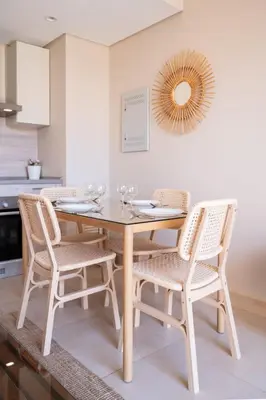 a dining room table with four chairs and a mirror at Seascape 1 BDR Mangroovy Pool & Sea View in Hurghada