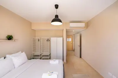 a small room with a bed and a refrigerator at Seascape 1 BDR Mangroovy Pool & Sea View in Hurghada
