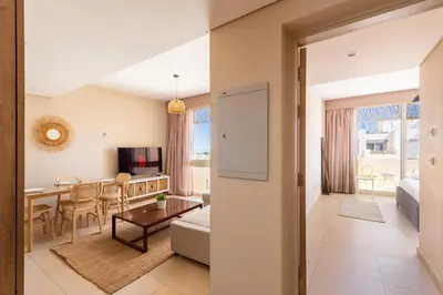 a living room with a table and a dining room at Seascape 1 BDR Mangroovy Pool & Sea View in Hurghada