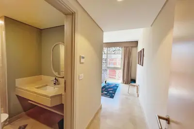 a bathroom with a sink and a mirror at Spectacular & Soaring 2 BDR w Private Rooftop Jacuzzi & Beach Access in Hurghada