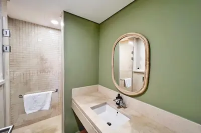a bathroom with a sink and a mirror at Spectacular & Soaring 2 BDR w Private Rooftop Jacuzzi & Beach Access in Hurghada