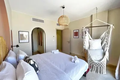 a bedroom with a bed and a swing at Spectacular & Soaring 2 BDR w Private Rooftop Jacuzzi & Beach Access in Hurghada