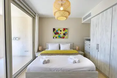 a bedroom with a bed with two towels on it at Sparky & Summery 2 BDR Mangroovy Free Beach & Pool Access in Hurghada