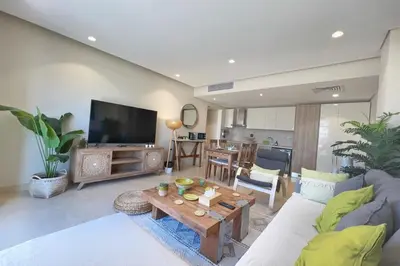 a living room with a couch and a table at Sparky & Summery 2 BDR Mangroovy Free Beach & Pool Access in Hurghada