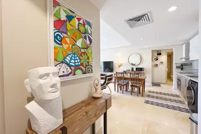 a kitchen and living room with a painting on the wall at Sparky & Summery 2 BDR Mangroovy Free Beach & Pool Access in Hurghada