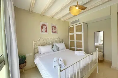a bedroom with a white bed with towels on it at Radiant & Ravishing 2 BDR Mangroovy Free Beach & Pool Access in Hurghada