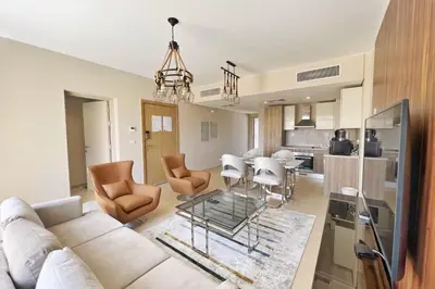 a living room with a white couch and a table at Charming 2BDR w Sea & Pool View Free Beach & Pool Access in Hurghada